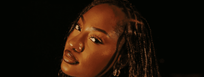 Woman with braids and glowing skin.